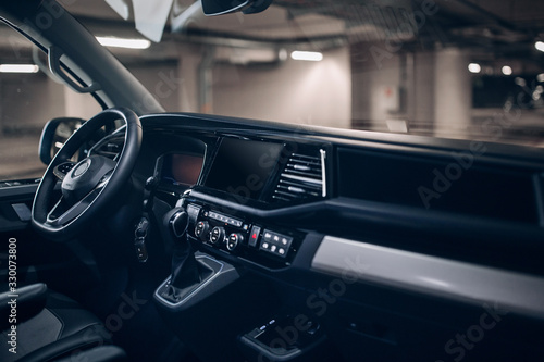 Luxury van driver seats with dashboard, multimedia control screen and steering wheel © Moose