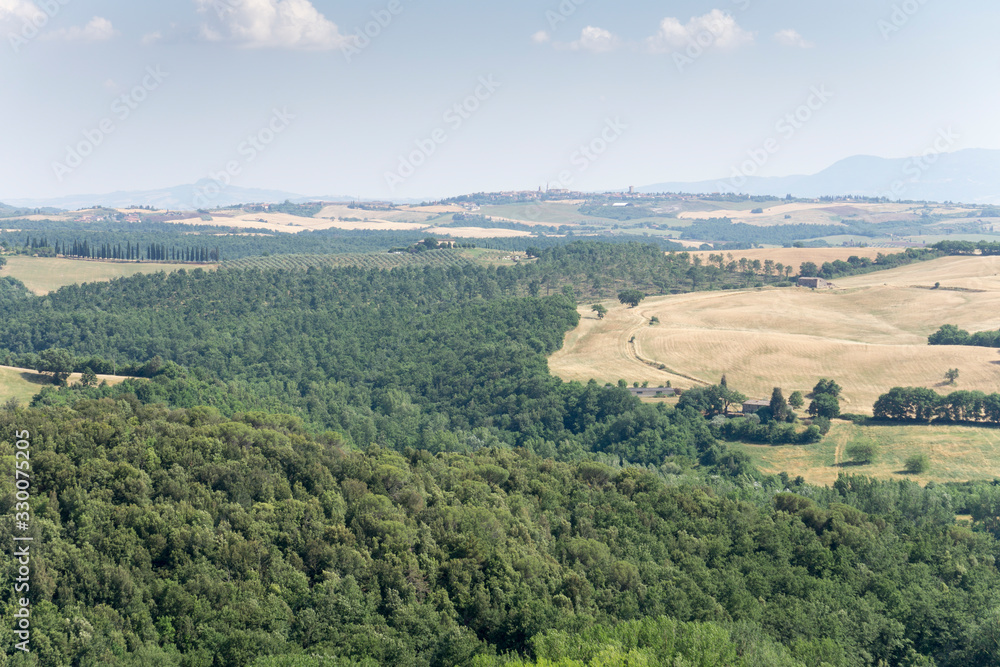 Obraz premium Castelmuzio, an ancient village dating back to the time of the Etruscans, is built on a volcanic limestone hilltop overlooking an amazing landscape Orcia valley Tuscany Italy on July 2019