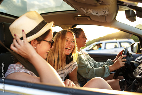 Group of best female friends travel together to summer adventure.They drives a car and making fun.  © BalanceFormCreative