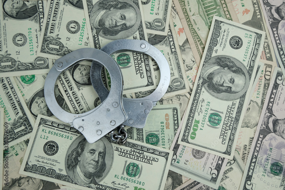 Handcuffs on money background.Concept of law, criminal, police. Handcuffs on money background.Concept of law, criminal, police.