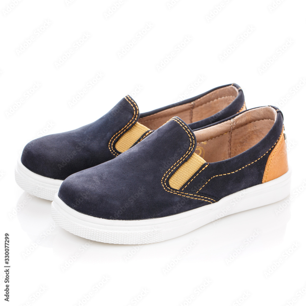 Blue suede shoes with orange inserts isolated on white. Side view Blue suede shoes with orange inserts isolated on white. Side view