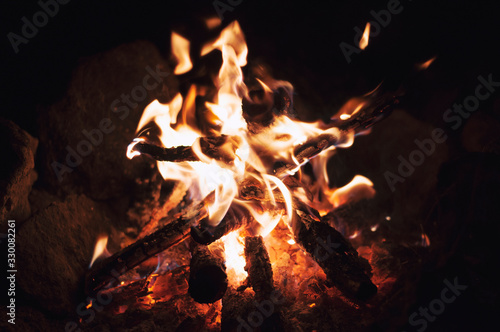 Fire wood brighly burning in furnace. Firewood burn in rural oven. Burning firewood in fireplace closeup. Fire and flames. Close up of burning fire wood in fireplace photo