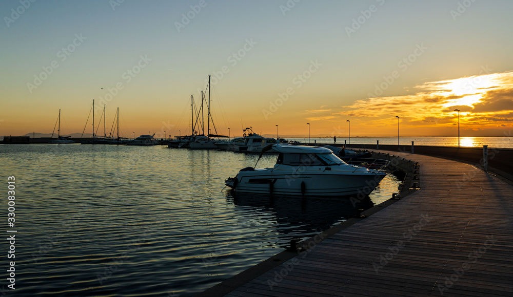Fototapeta premium Sunset light in a harbor the Spanish town Roses in Costa Brava,Catalonia,Spain