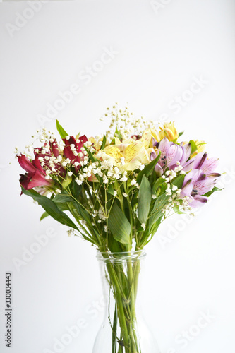 Alstroemeria flowers in vase isolated on white