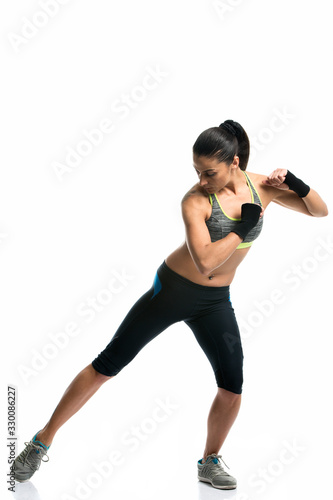 brunette young woman exercising isolated on white