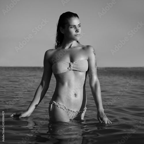 girl looking to sunset on sea black and white