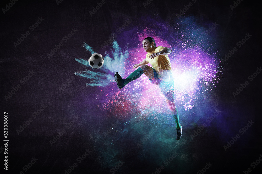 Boy playing soccer hitting the ball