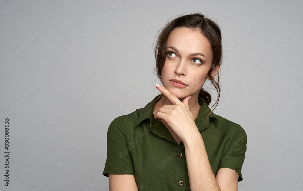 Young woman is thinking and looking up. Isolated Young woman is thinking and looking up. Isolated