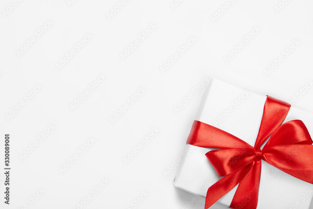 Box with red ribbon and bow isolated on white with copy space. Box with red ribbon and bow isolated on white with copy space.