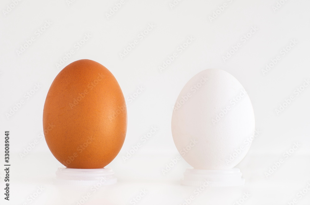 Brown and white eggs next to eachother Brown and white eggs next to eachother