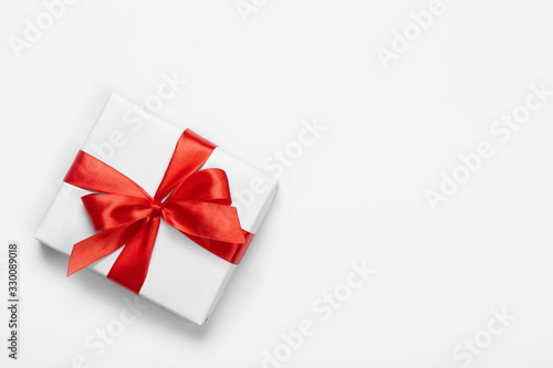 Box with red bow isolated on white background