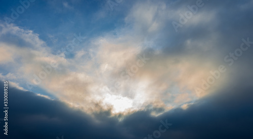 Dramatic cloudscape Sun piercing through the clauds