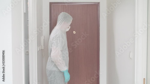 Person wear protective pandemic clothing decontaminate with spray 4K