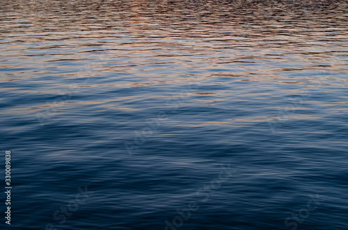 Abstract calm sea water waves pattern at dusk