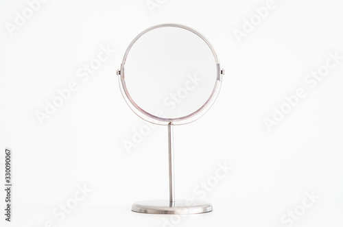 Magnifying mirror on stand isolated
