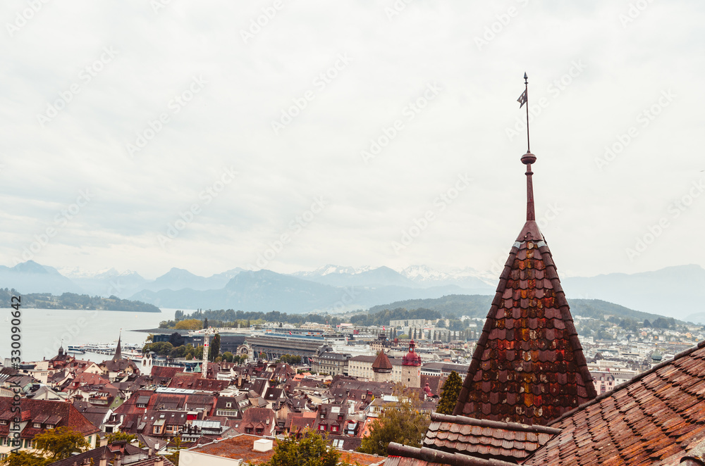 Aerial view of the city of Lucern Switzerland on an overcast day mountains in the background