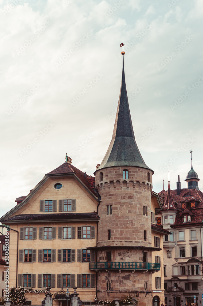 Old stone tower house in Lucern Switzerland overcast day old city center 2019
