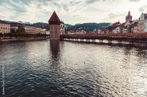 View of the Kappelbrucke wooden bridge and tower on a cloudy day - 2019