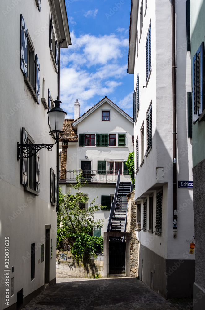 Zurich city old and narrow alley white wall building sunny day blue sky