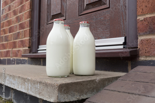 Fresh milk in recyclable glass bottles delivered to the door by a traditional milk man