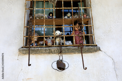 Craveggia (VCO), Italy - June 2, 2018: Dolls at window in Craveggia village, Vigezzo Valley, VCO, Piedmon, Italy photo