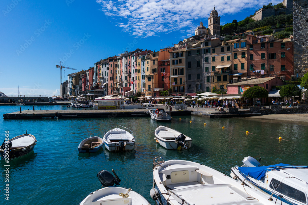 Portovenere La Spezia Italy coloured building in the old town sen from the pier with small boats on a sunny summer day