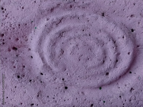 Concrete purple fence with abstract circles, background or texture