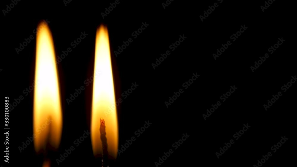 burning candle on blackbackground burning candle on blackbackground