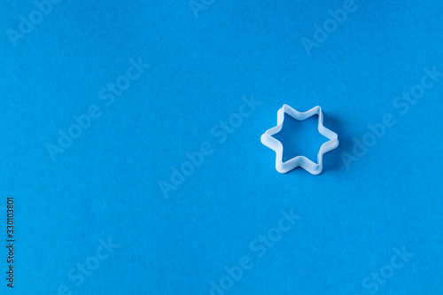 plastic molds for baking cookies in the form of stars on a blue background