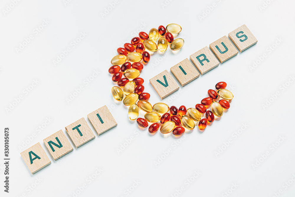 the letter c made from transparent pills next to the inscription antivirus on a white background