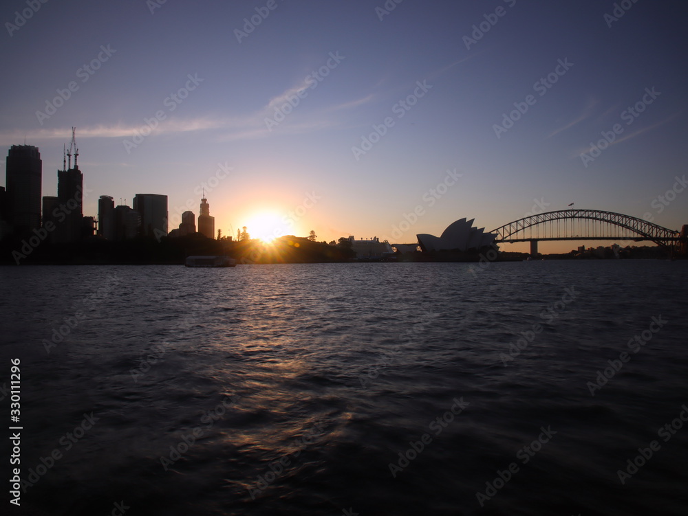 Panoramic View of Sydney Harbour on a warm summer afternoon blue and orange skies illuminating Sydney Harbour Bridge