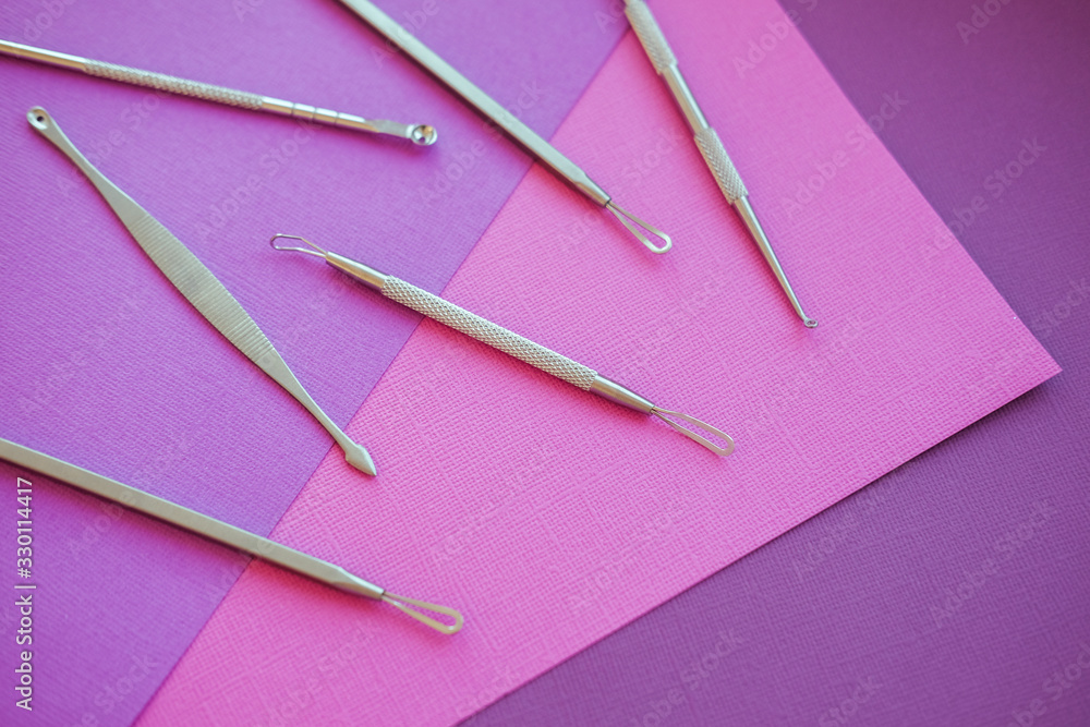Tools for removing acne. Tools of the cosmetologist for problem skin on pink paper background. Tools for removing acne. Tools of the cosmetologist for problem skin on pink paper background.