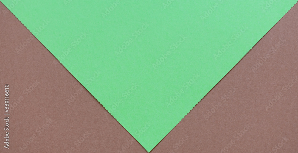 Soft brown and bright green cardboard background, two brown triangles Soft brown and bright green cardboard background, two brown triangles