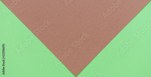 Soft brown and bright green cardboard background, two green triangles