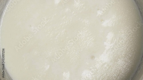 Boiling French bechamel sauce. Haute cuisine. French traditional food. Macro vertical shot