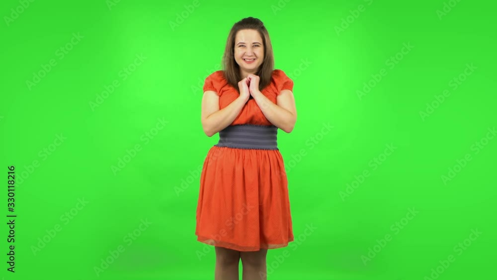 Cute girl looking with tenderness with folded arms in front of her. Green screen Cute girl looking with tenderness with folded arms in front of her. Green screen