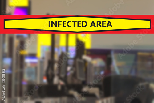 Blurred airport or station background with a banner warning that the area is infected