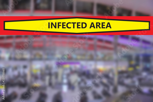 Blurred airport or station background with a banner warning that the area is infected