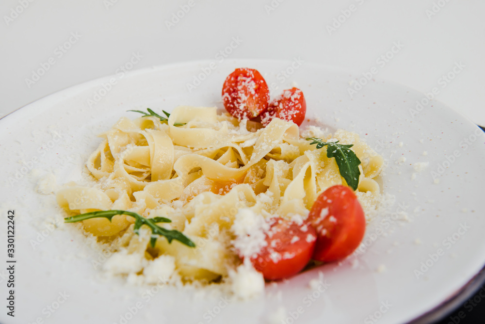 Classic italian spaghetti pasta with cherry tomatoes and cheese parmesan