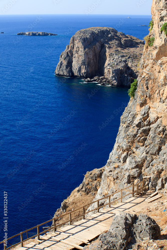 Lindos, Rhodes / Greece - June 23, 2014: The cliffs view near Lindos, Rhodes, Dodecanese Islands, Greece.