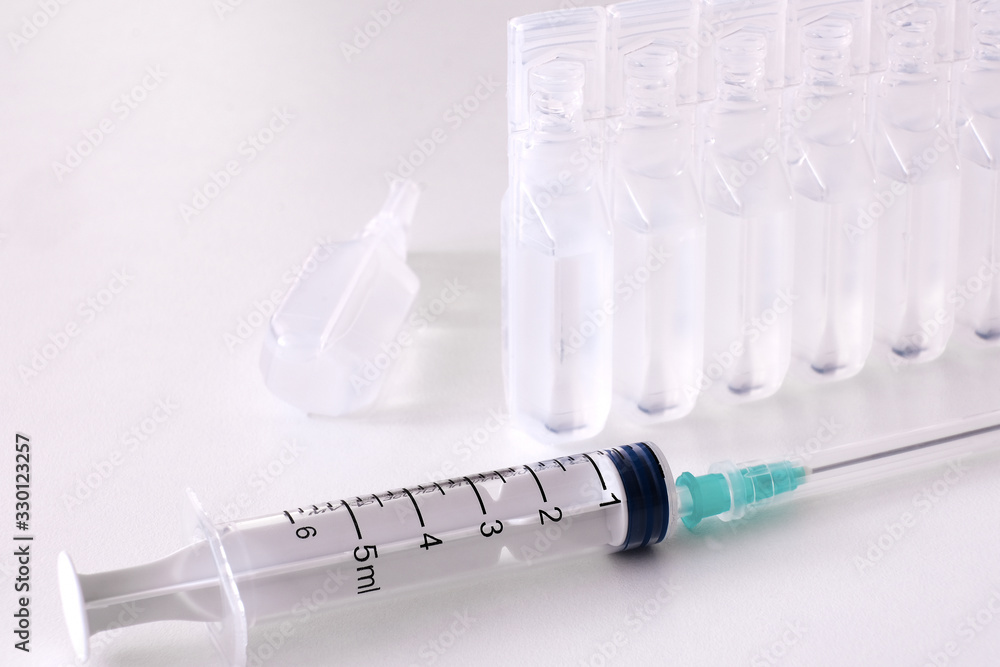 Syringes, water for injection, vials of vaccine. The concept of vaccination. Syringes, water for injection, vials of vaccine. The concept of vaccination.