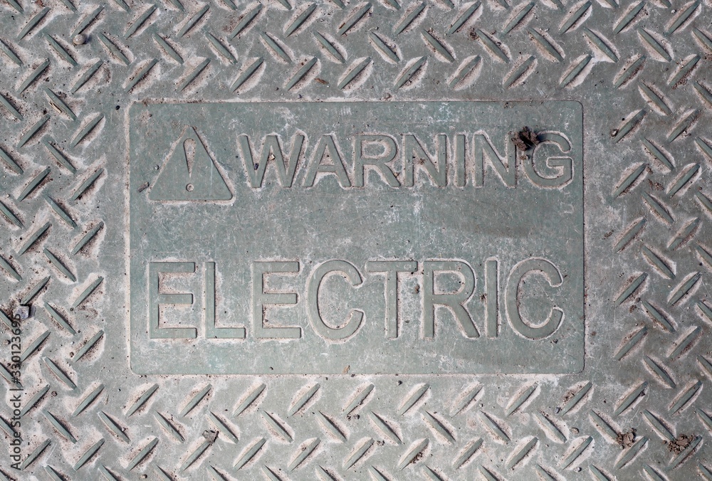 A close view of the metal electric warning sign. A close view of the metal electric warning sign.