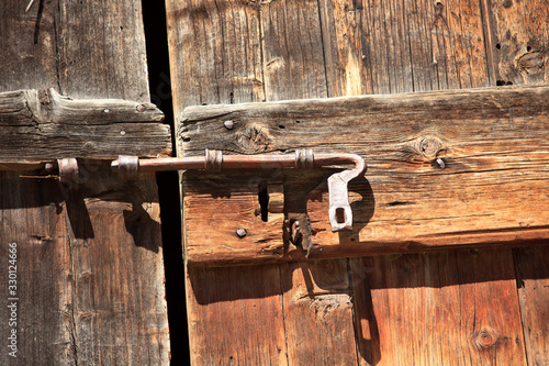 Ponte (VCO), Italy - March 06, 2017: A door's bolt in Walser house,  Formazza Valley, Ossola Valley, VCO, Piedmont, Italy photo