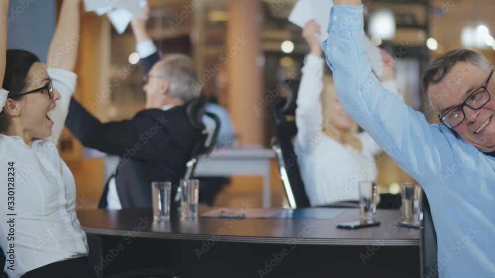 Group of confident business people throwing paper in air Group of confident business people throwing paper in air