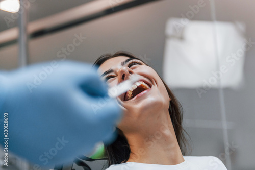 Cheerful woman have a visit in the dentist clinic. Conception of stomatology