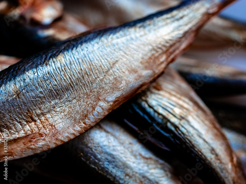 Cold smoked salaka ready to eat. Smoked fish close-up on a plate. Sea fish is a tasty and healthy natural food product, rich source of essential Omega-6 fatty acids or polyunsaturated fat acid oil photo