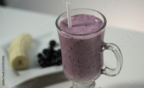 Milk banana cocktail with black currant