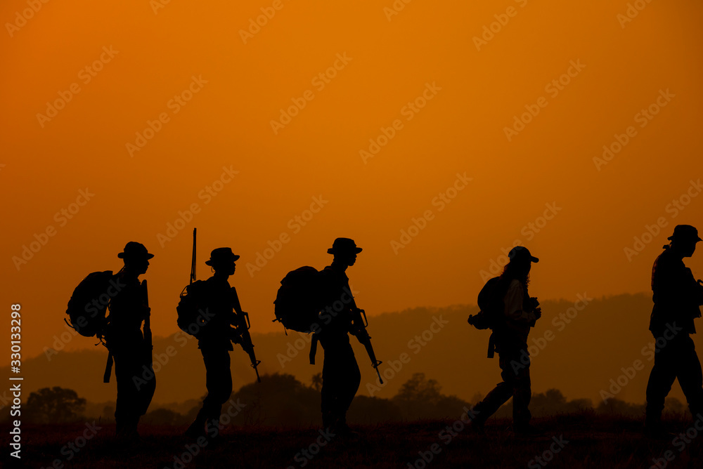 silhouettes of people on sunset background