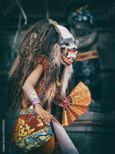 Dancer in traditional Balinese mask of demon Rangda photo