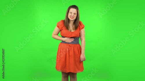 Cute girl is feeling very bad, her stomach hurting . Green screen